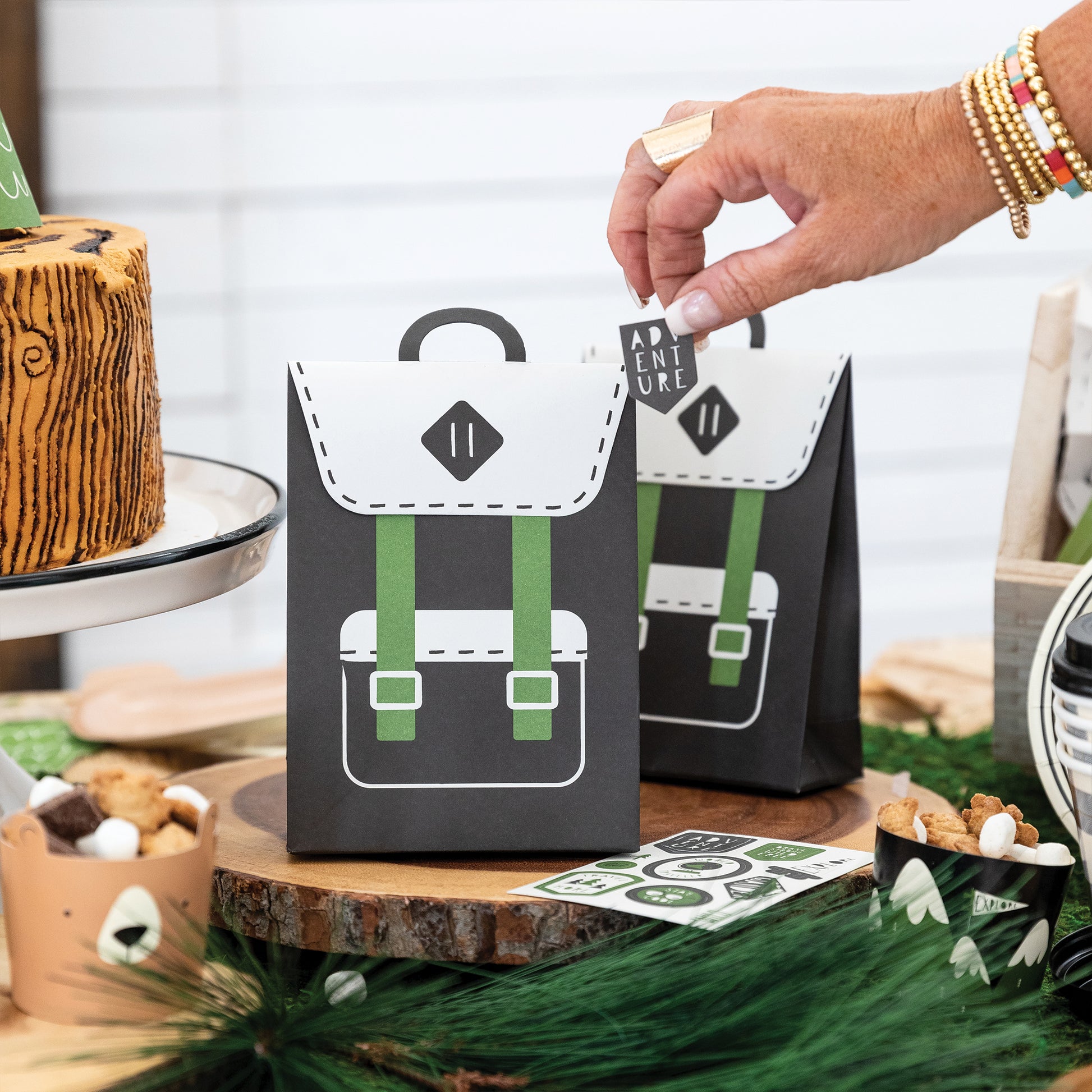 Black and Green backpack style treat/ favour party bags with sticker. This is an adventure/ happy camper birthday theme.