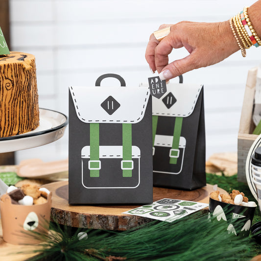 Black and Green backpack style treat/ favour party bags with sticker. This is an adventure/ happy camper birthday theme.