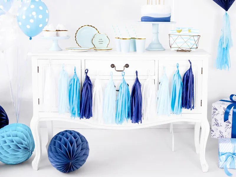 Tassel Garland set-up surronded bydark and light blue honecombs, blue with gold trim cups and blue plates and balloons