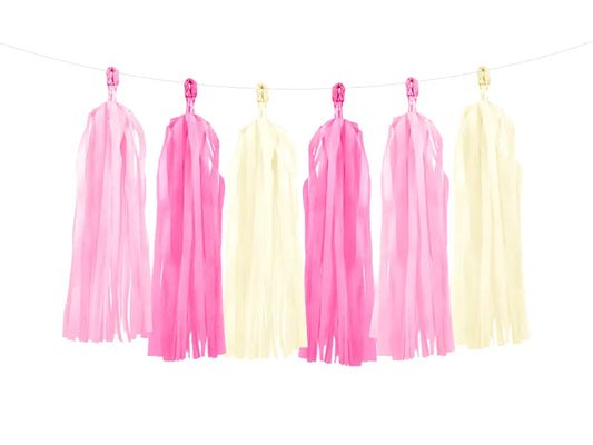 Light pink, dark pink, white, dark pink, light pink and white tassel garland on clear twine.