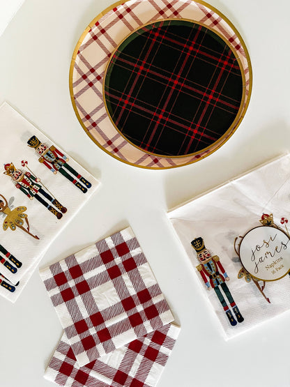 red and cream farmhouse plaid paper napkins set-up with nutcracker design napkin and farmhouse low rim shallow plates. 