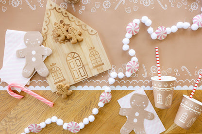 Gingerbread theme table set-up ith matching tablerunner, gingerbread shaped napkins and cups