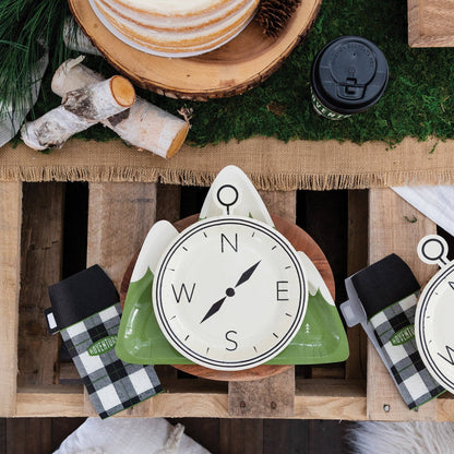 Compass shaped party plate table setiing. Mountain shaped paper plate and thermal black and white checkered napkins.