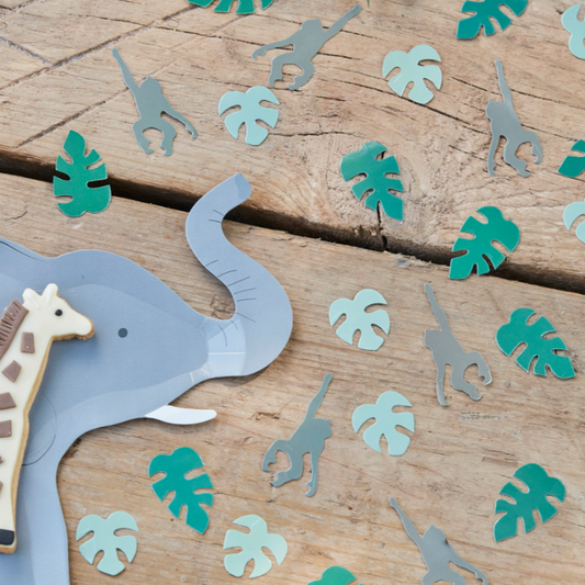 Table setting with elephant shape plate. Table confetti mix of leaf and hanging monkey. 