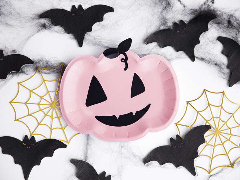 Pink Pumpkin Shape Paper Party Plate with Black eyes, face design. Table setting with gold spider webs and black bat shape paper napkins