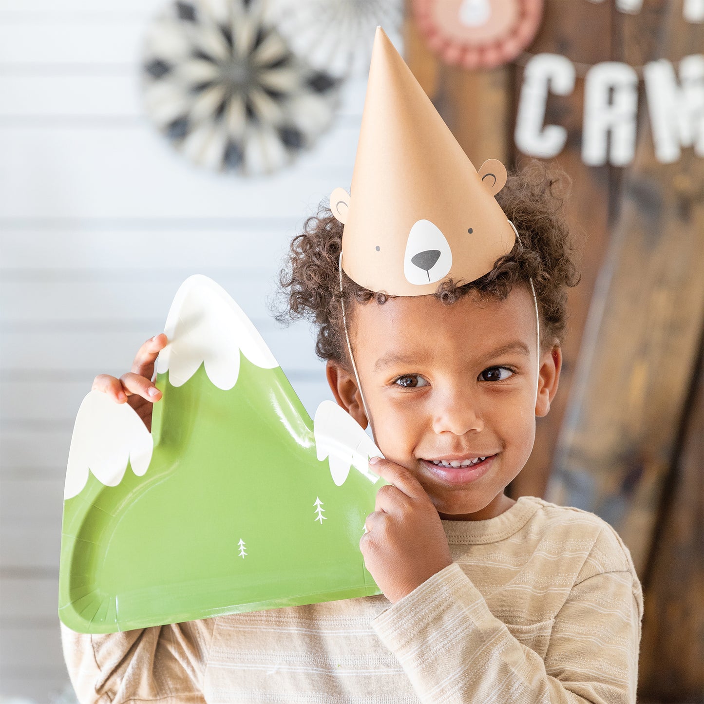 Picture of boy with Bear Party hat holding a moutain shaped paper plate